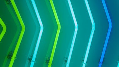 blue and green striped neon arrows pointing to the right
