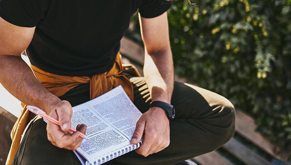 man writing notes 