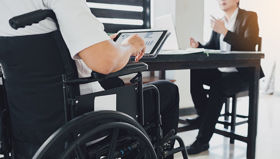 person in wheelchair with laptop