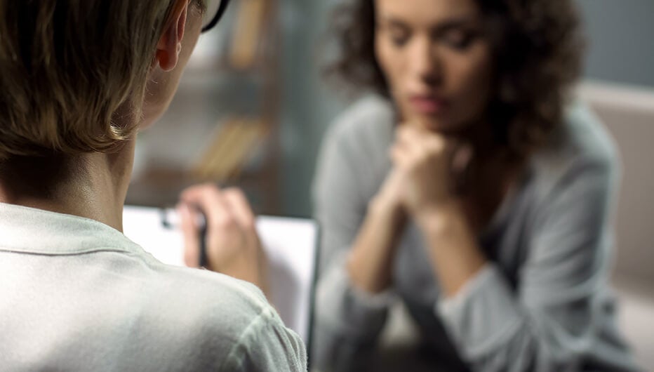 woman taking  down notes during job interview