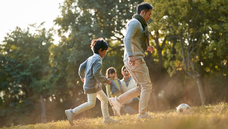 Family playing with football