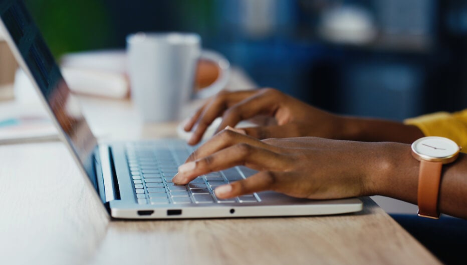 woman typing on her laptop