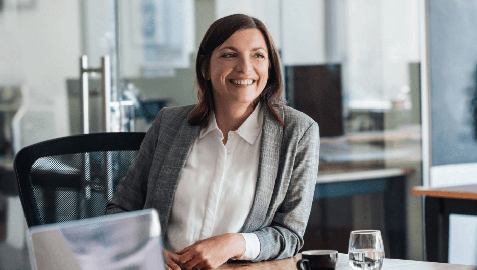 woman in blazer smiling