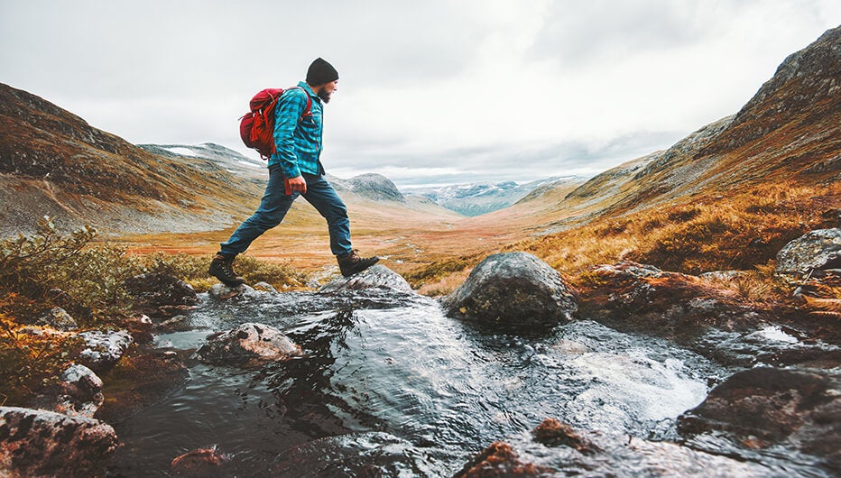 man walking on rock