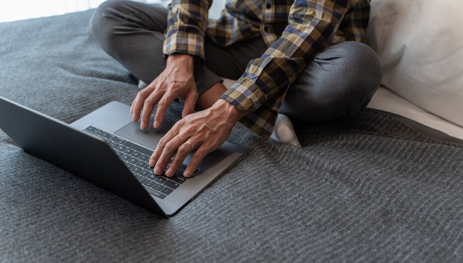 man on floor with laptop