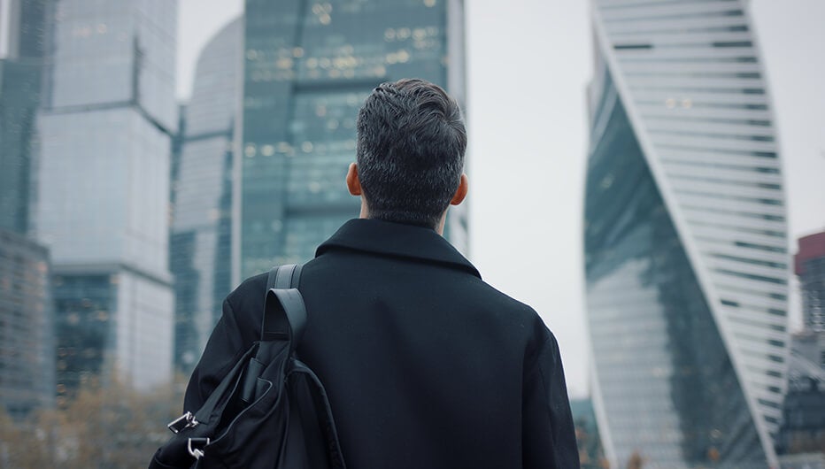 man looking at building