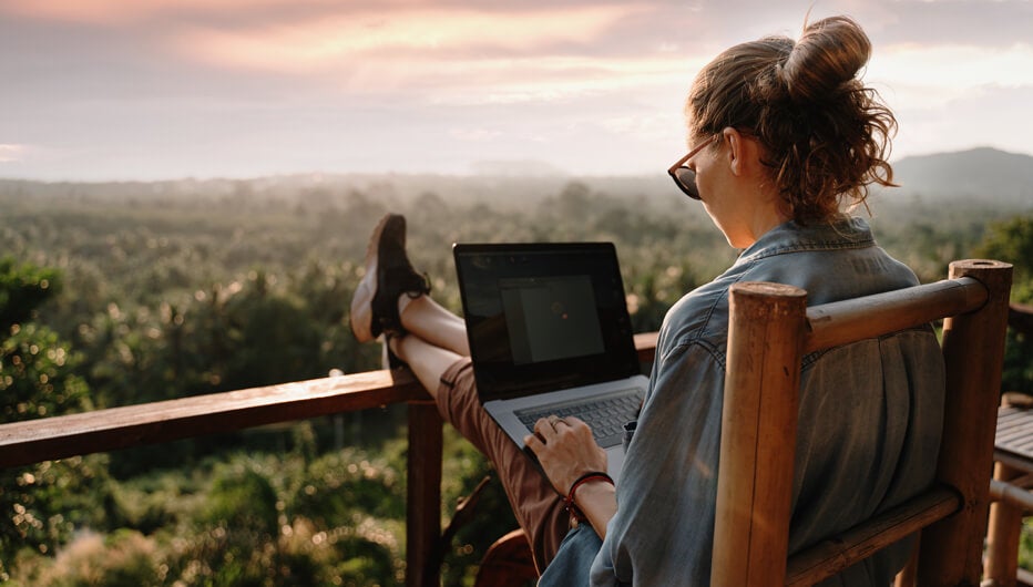 woman on balcony with laptop