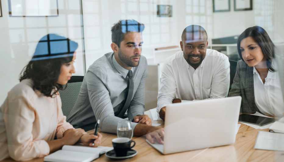 colleagues around computer