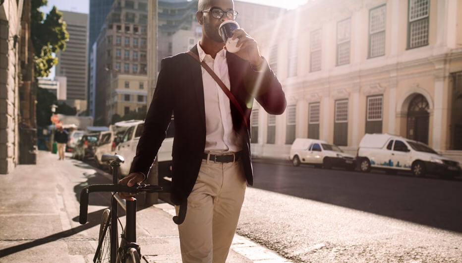 man walking with bike in sunshine