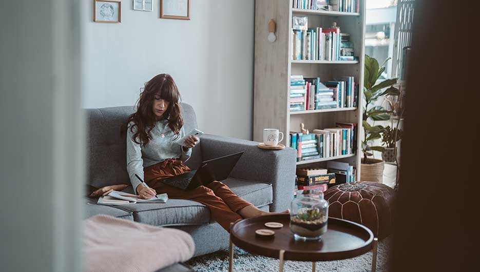 woman on couch working