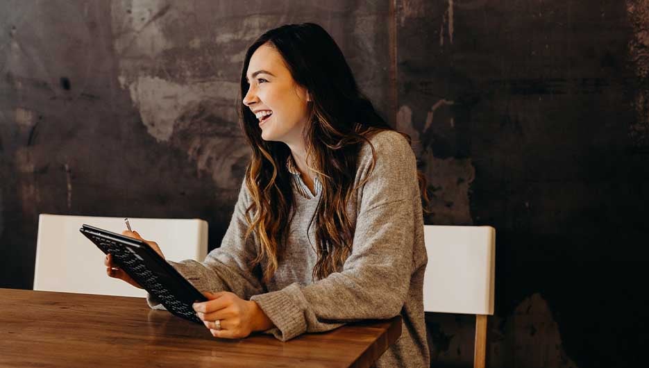 woman smiling with ipad